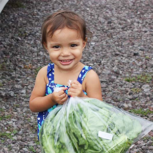 toddler holding lettuce